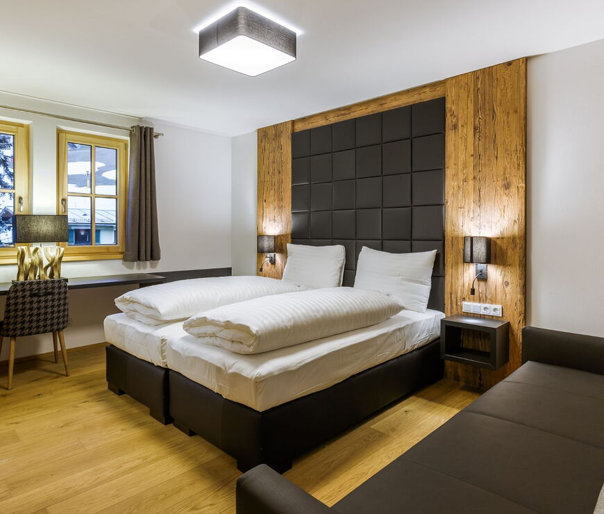 Bolodges Apartments Saalbach: Schlafzimmer mit Doppelbett und Couch